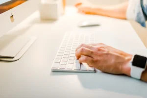 Mano sobre teclado simbolizando que el branding va mas alla del diseno